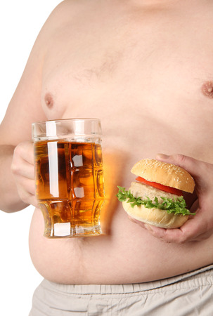 Large belly and a mug of beerの写真素材
