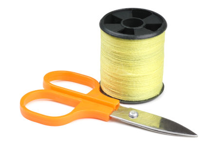 Coils threads and scissors on a white background