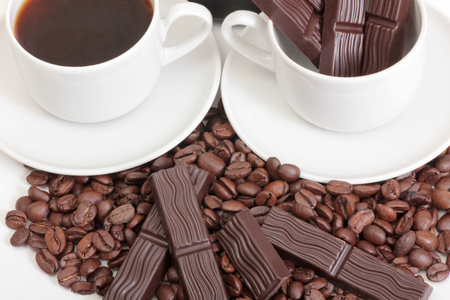 Coffee cup and chocolate on a white backgroundの写真素材