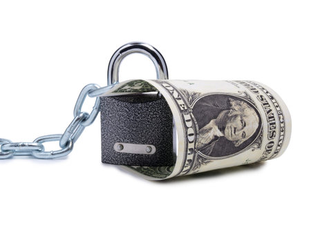 Paper dollars and lock on a white backgroundの写真素材