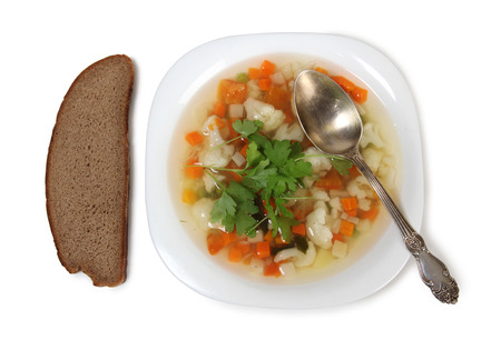 Porcelain plate with vegetable soup on white backgroundの写真素材