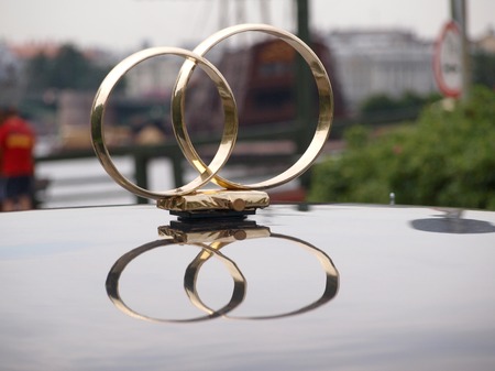 Wedding rings on the car roofの写真素材