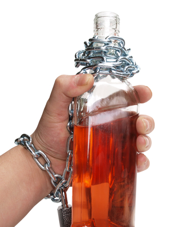 Wineglass of whiskey in man handの写真素材