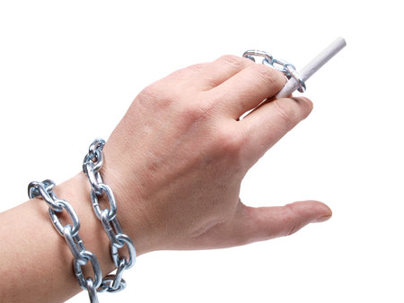 Cigarettes and hand with chain on white backgroundの写真素材