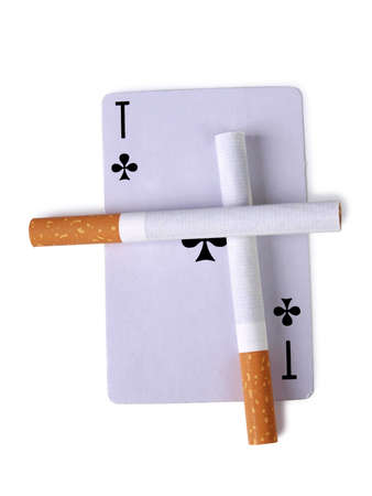Cigarette with a filter and playing cards on a white backgroundの写真素材