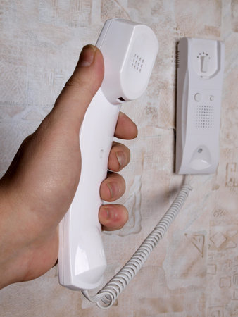 Man's hand with a telephone receiver