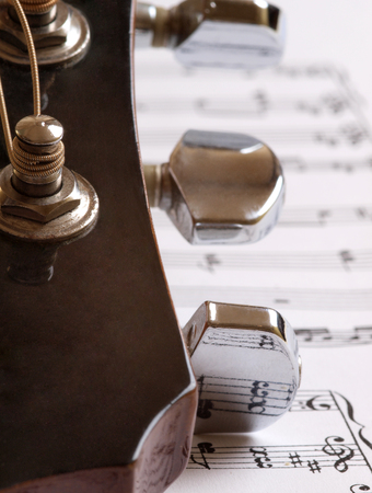 Acoustic guitar trunks on the background of sheet with notesの写真素材