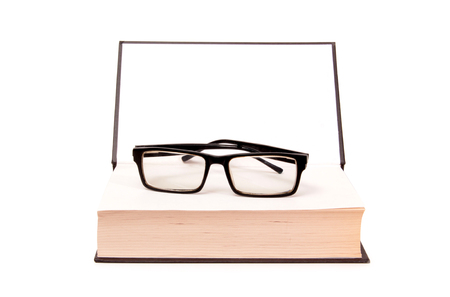 Glasses and old paper books on a white backgroundの写真素材