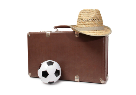 Old suitcase and soccer ball on white backgroundの写真素材