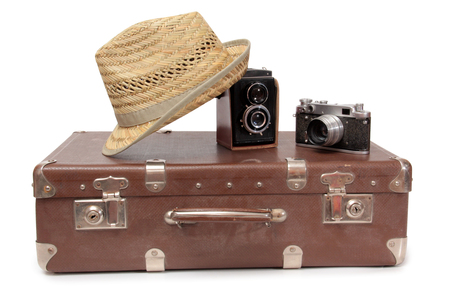 Vintage suitcase and old camera on a white backgroundの写真素材