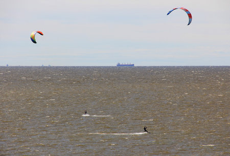 Athlete on a parachute surfboard on sea