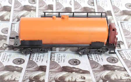 Oil tank and paper dollars on a white background