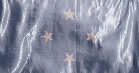 State flag fluttering in the wind. Colored background on textilesの写真素材