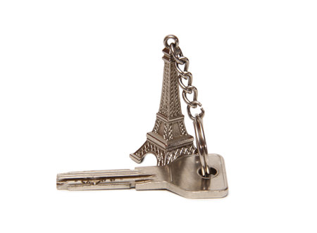 Apartment keys and Eiffel Tower keychain. Isolated items on white backgroundの写真素材