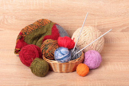 Multicolored balls of wool on a wooden table