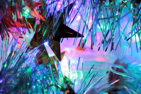 Christmas garland of electric multi-colored light bulbs. Abstract blurred backgroundの写真素材