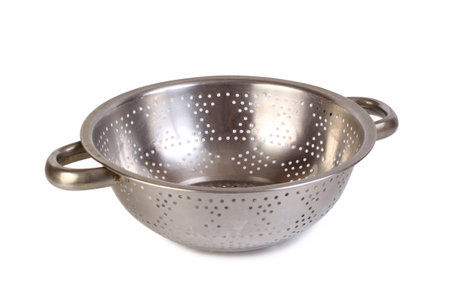 Large metal colander. Isolated object on white background