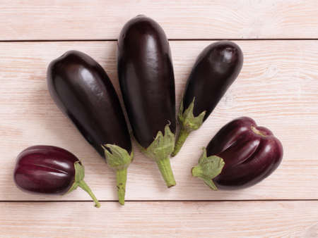 Eggplant on a kitchen scale on a wooden tableの写真素材
