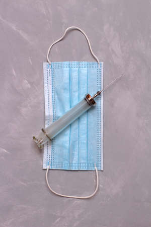 Disposable medical glasses syringes lie on stone tableの写真素材