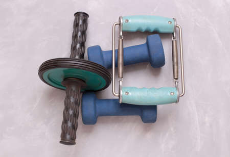 Blue dumbbells for home fitness supply. Objects on a stone backgroundの写真素材