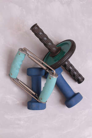 Blue dumbbells for home fitness supply. Objects on a stone backgroundの写真素材