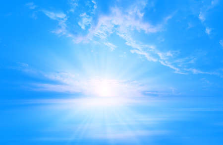 Blue sunset over the sea, light clouds, rays of lightの写真素材