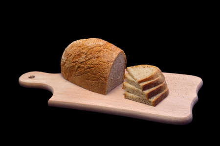 Bread, sliced ââon a kitchen board  Isolated on black backgroundの写真素材