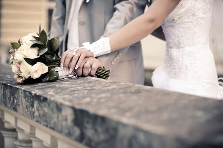 couple s hands holding wedding bouquet of flowers  Imitation of antiquityの写真素材