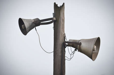 Two old mouthpieces on the old wooden pillar  Imitation of antiquity の写真素材