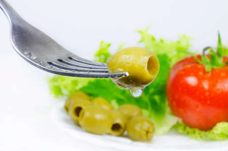 closeup of mixed vegetable salad with forkの写真素材