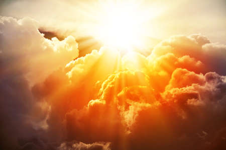 The bright rays of the sun are shining from saturated clouds