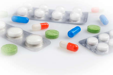 Many different pills on white background, copy space above the pillsの写真素材