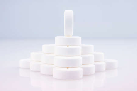 Close-up. Pharmacy theme. Wall of white tablets on a light surfaceの写真素材