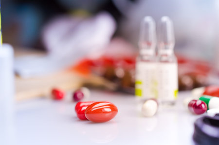 Many different medications on a white surface.