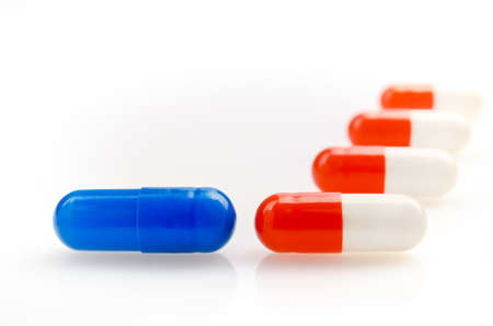 Red and Blue Capsules on a White Backgroundの写真素材
