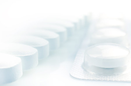 Closeup. Pharmacy theme. White Pills on the White Background
