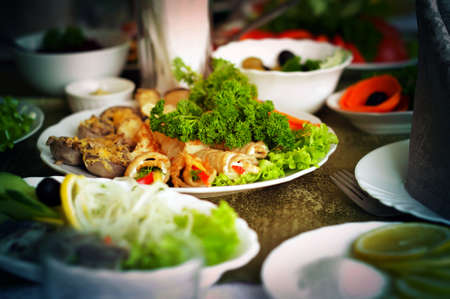 Assorted of Baked Mushrooms and Greens on a White Plate, on a Festive Tableの写真素材
