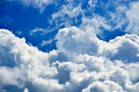 Blue sky with white and gray cumulus clouds. Closeup