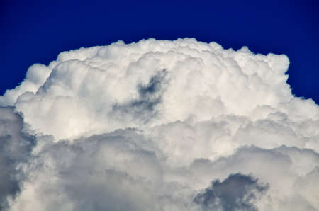 Blue sky with white and gray cumulus clouds. Closeupの写真素材