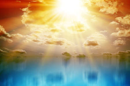 Colored Sunset. Sky with clouds and sun over blue seaの写真素材
