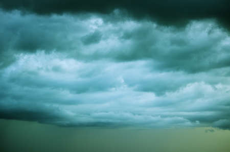 Dark rain clouds in the sky. In the background, it's raining.の写真素材