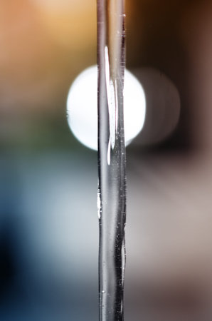 Frozen water jet on the background of light bokeh