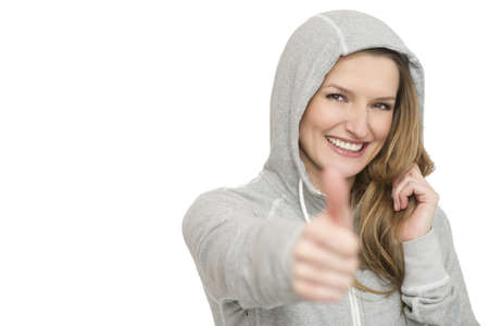 Young sport woman showing thumbs up gesture, isolated over white backgroundの写真素材