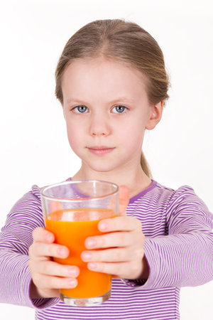 Young girl drinking orange juice - healthy lifeの写真素材