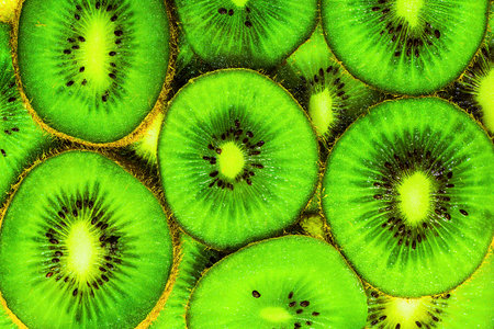 Background kiwi fruit slicesの写真素材