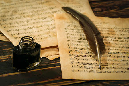 Quill, the inkwell and the scroll with musical notationの写真素材