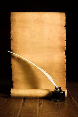 Inkwell with a light pen, rolls of papyrus on the backgrouの写真素材