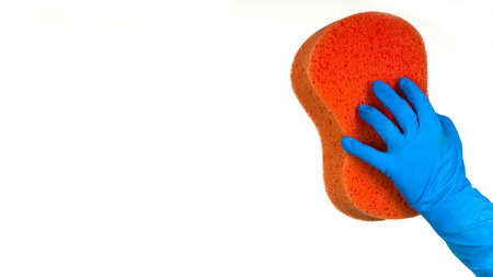 Hand in the blue glove with the red sponge for washingの写真素材