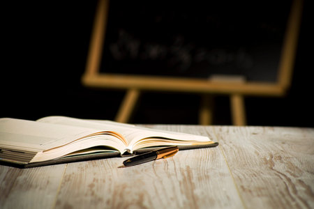 Concepts at the school, notebooks and the feather relating to the chalkboard