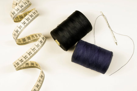 The concept of tailoring - thread reels, tailoring scissors, measuring tape